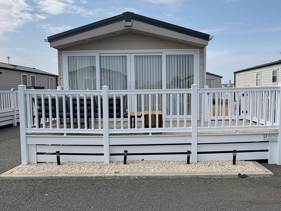An outdoor patio area with furniture at Lyons Robin Hood in Rhyl