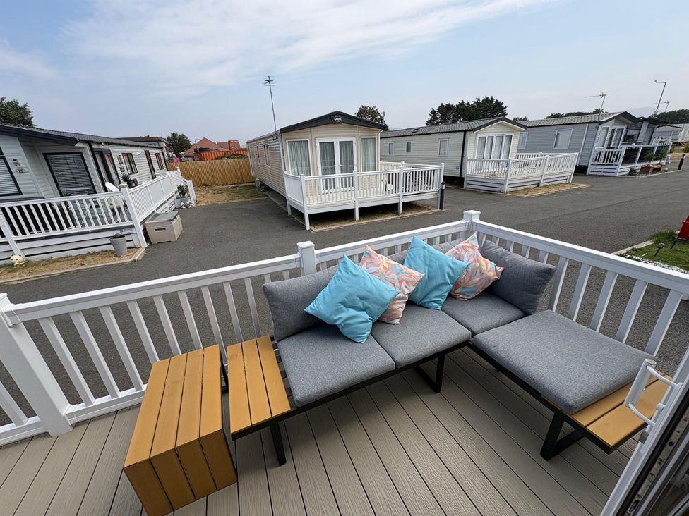 A sofa with cushions on an outdoor patio at Lyons Robin Hood in Rhyl