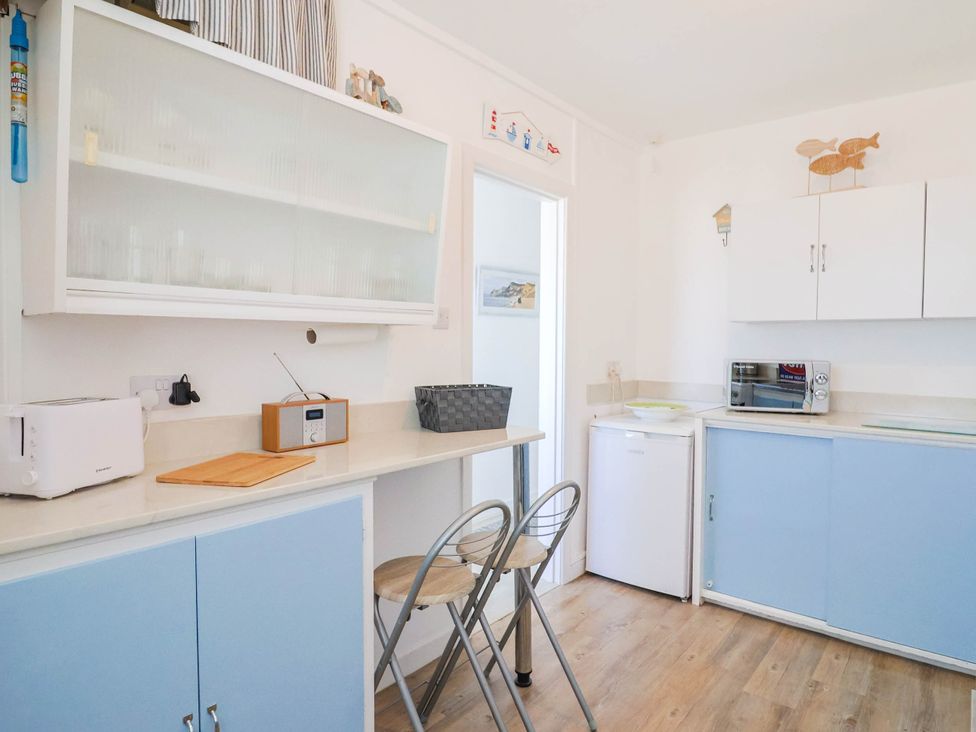 A kitchen with a toaster and radio at 16 Old Shipyard Centre in West Bay