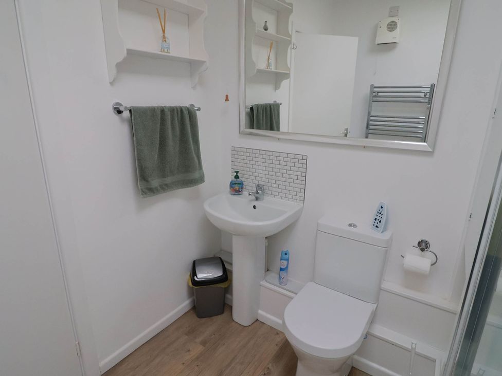 A bathroom with a sink and toilet at 16 Old Shipyard Centre, West Bay
