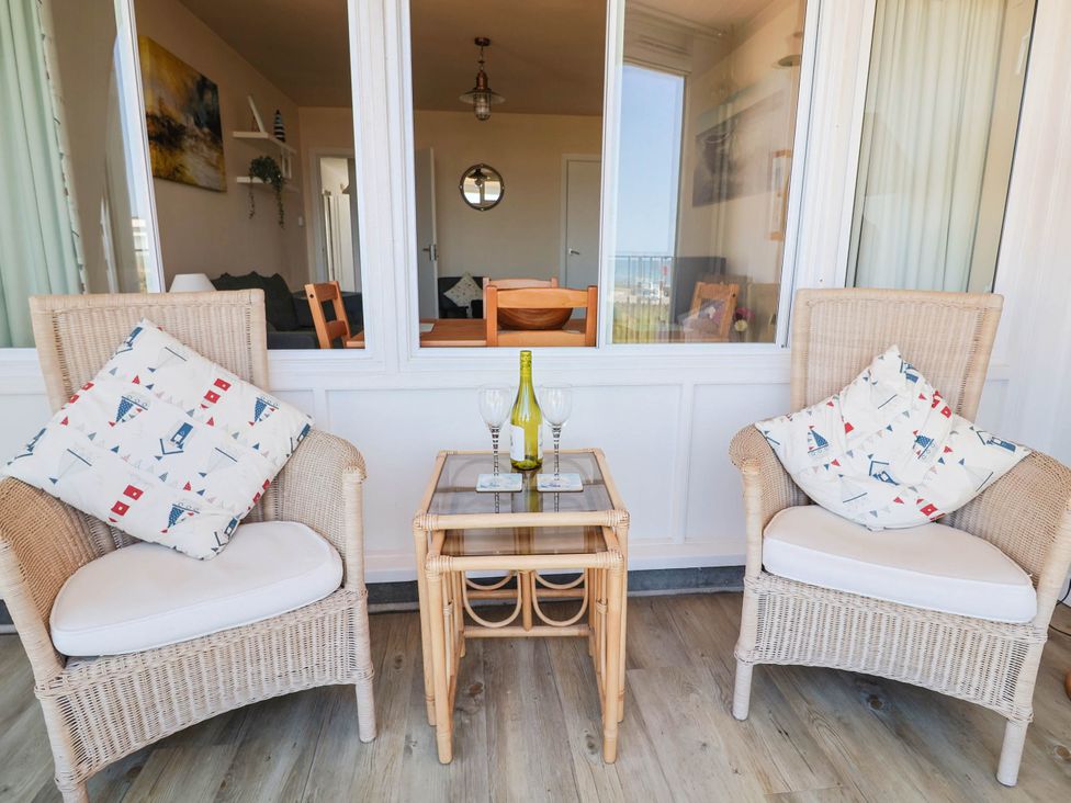 A living room with chairs and a table at 16 Old Shipyard Centre in West Bay