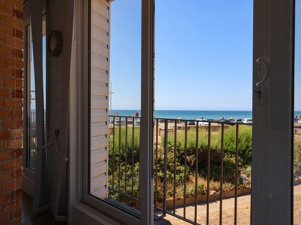 A view of the sea through a window at 16 Old Shipyard Centre, West Bay