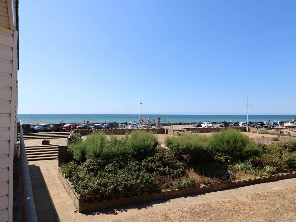 A view of the sea and cars by the promenade at 16 Old Shipyard Centre, West Bay