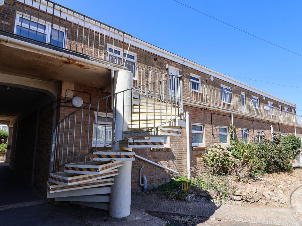 An exterior view of a building with a spiral staircase at 16 Old Shipyard Centre West Bay