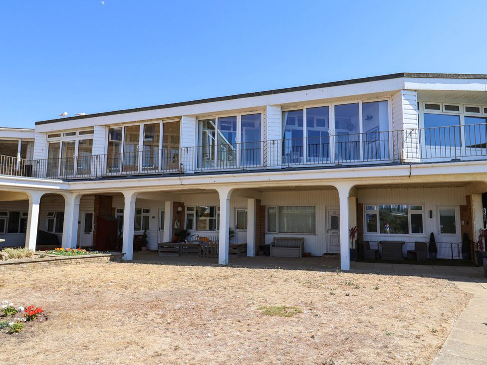 A building with balconies and outdoor seating at 16 Old Shipyard Centre, West Bay