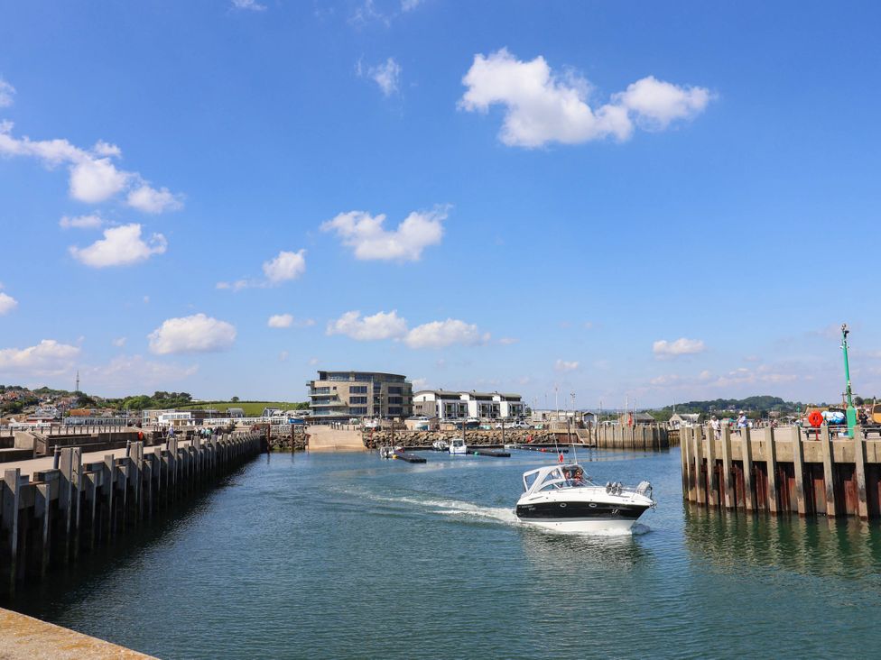 A harbor with boats and a pier at 16 Old Shipyard Centre West Bay