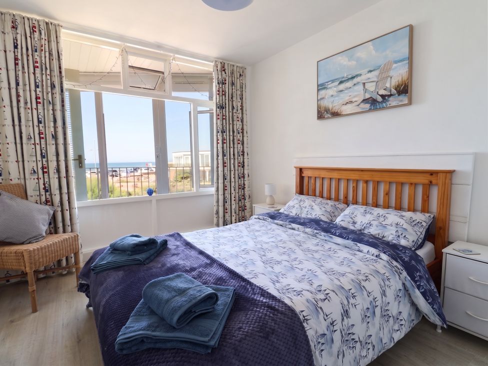 A bedroom with a bed and window view at 16 Old Shipyard Centre West Bay