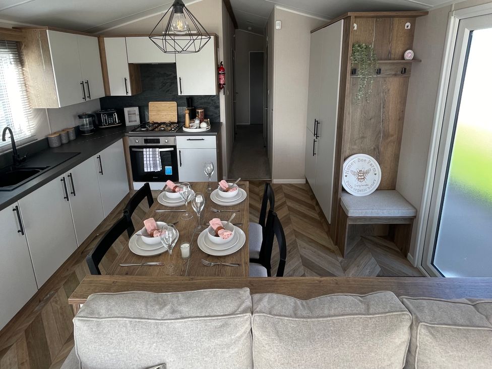 A kitchen with a dining table and chairs at Unity Beach in Burnham-on-Sea