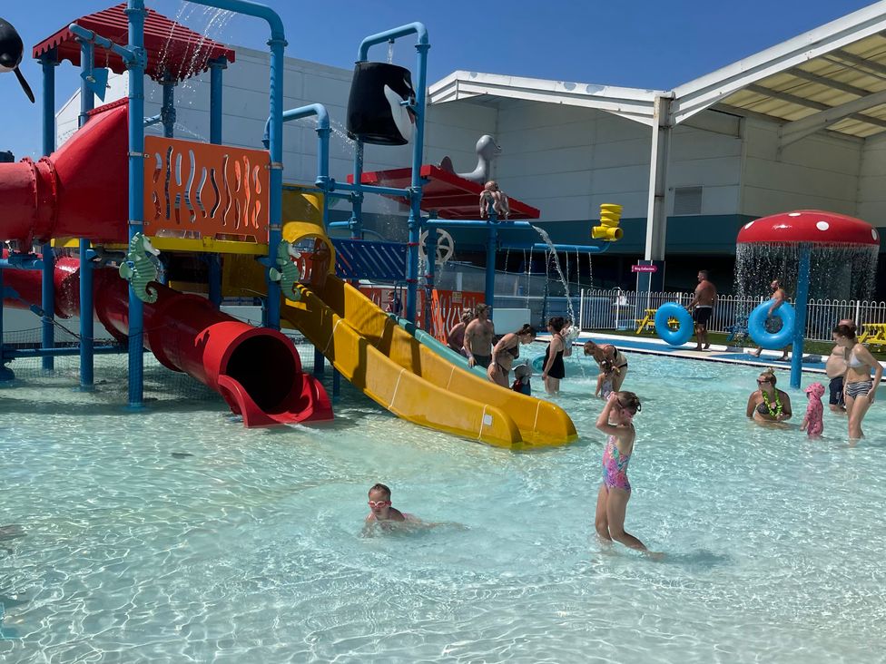 A water play structure with slides and children playing at Unity Beach Burnham-on-Sea