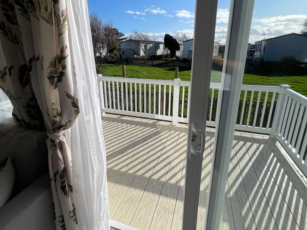 A view from a deck with a garden at Unity Beach Burnham-on-Sea