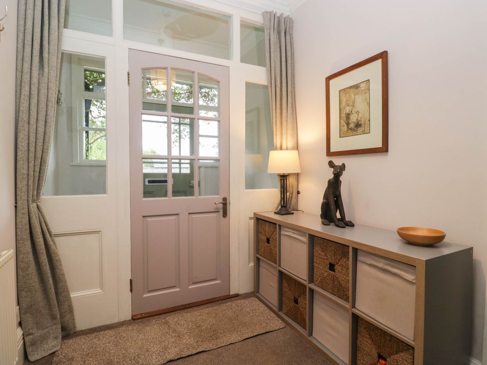 An entrance hall with a front door and storage unit at Briargarth in Keswick