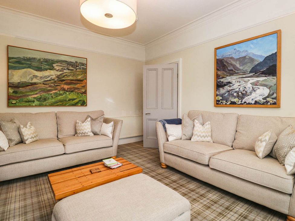 A living room with sofas and paintings at Briargarth in Keswick