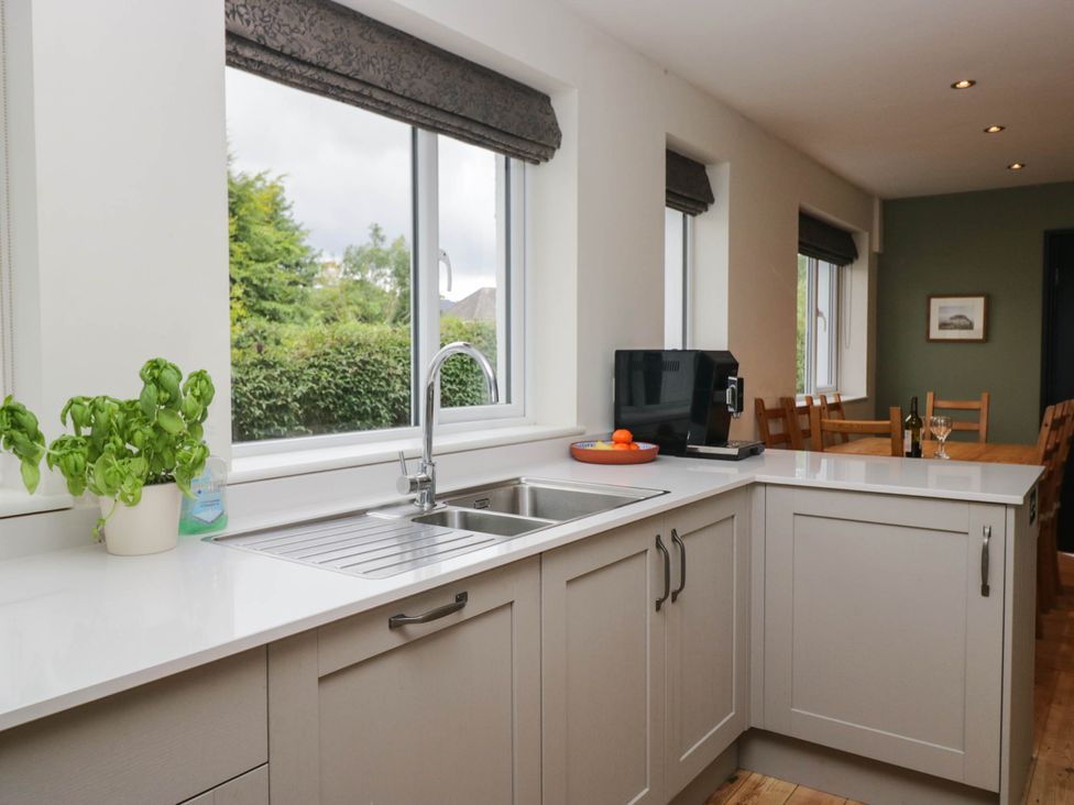 A kitchen with a sink and windows at Briargarth in Keswick