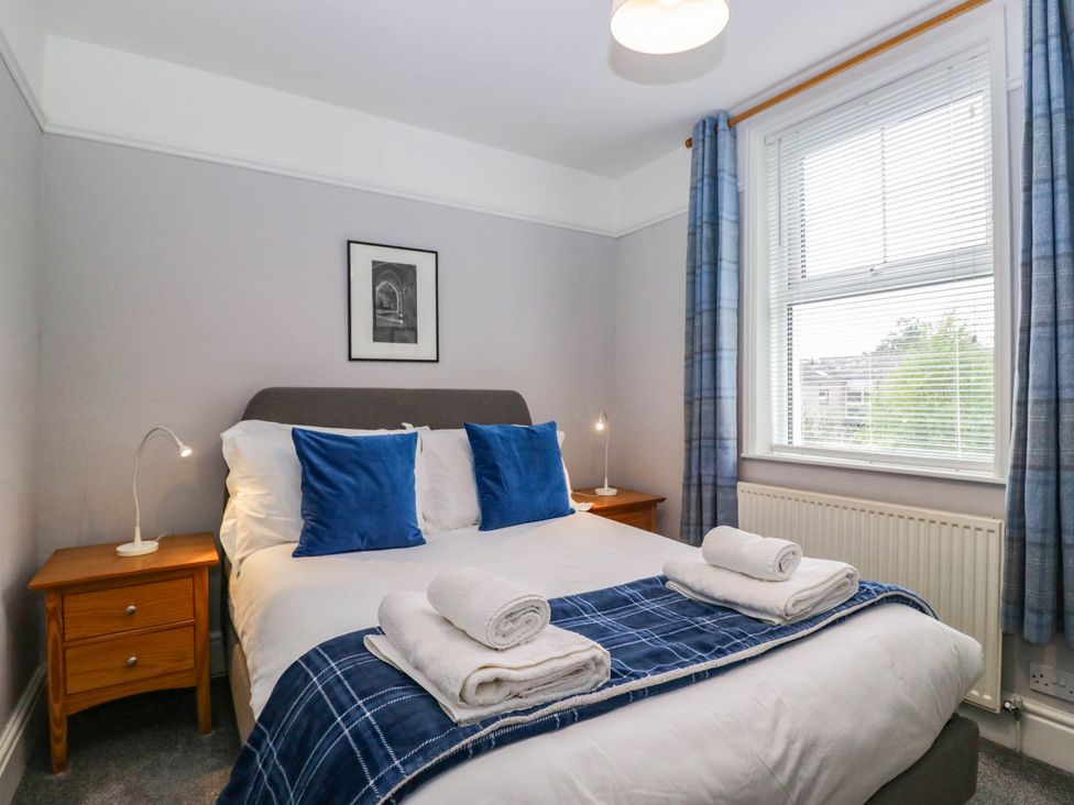 A bedroom with a bed and bedside table at Briargarth in Keswick