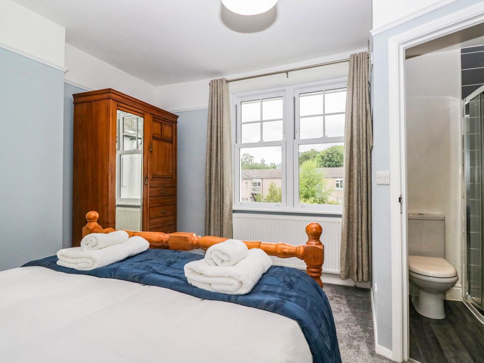A bedroom with a bed and wardrobe at Briargarth in Keswick
