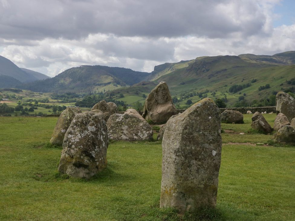 Standing stones in a field with mountains in the background at Briargarth in Keswick