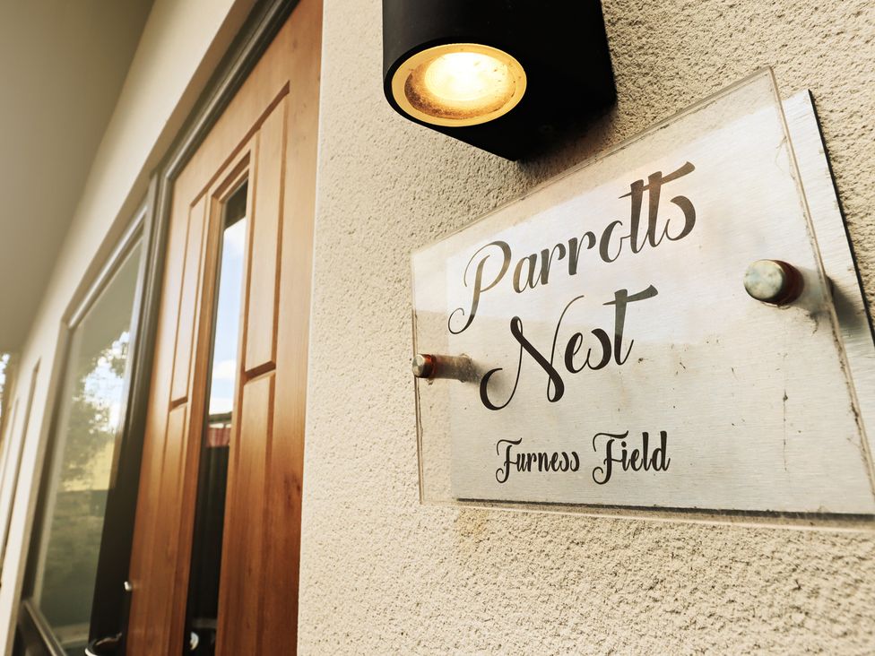 A door with a sign displaying Parrott's Nest at Parrott's Nest in Hyde