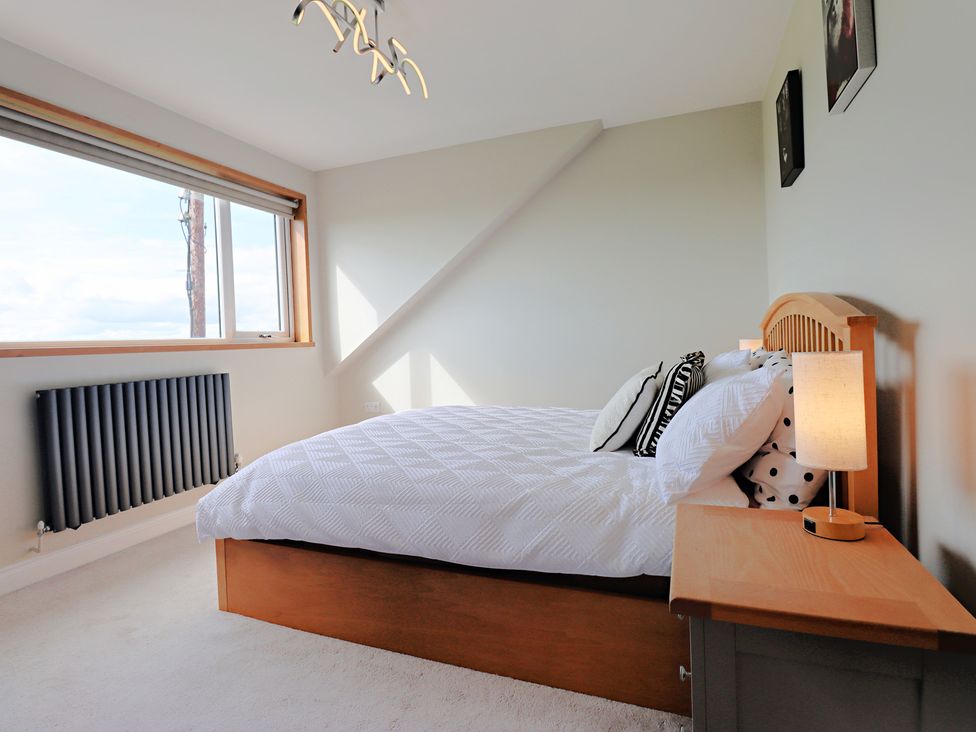 A bedroom with a bed and lamp at Parrott's Nest in Hyde