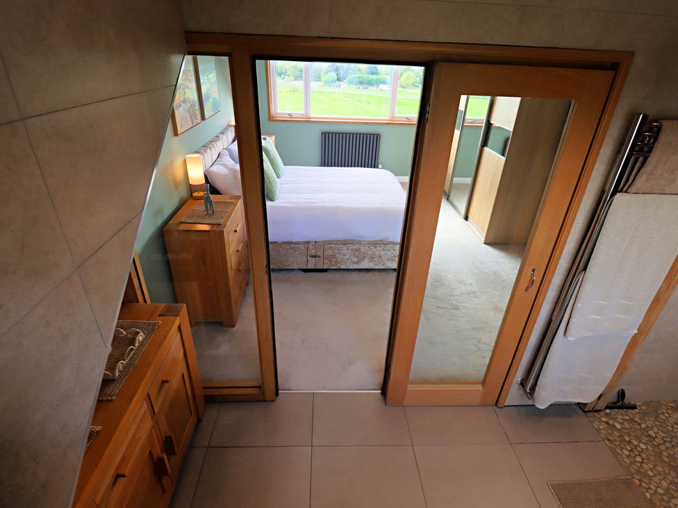 A bedroom with a bed and furniture at Parrott's Nest in Hyde
