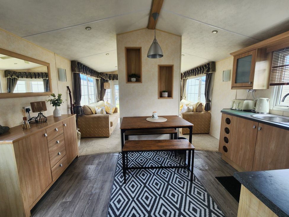 A living room with seating and a dining table at Whitley bay parkdean resorts - 52 Beechfield, Whitley Bay