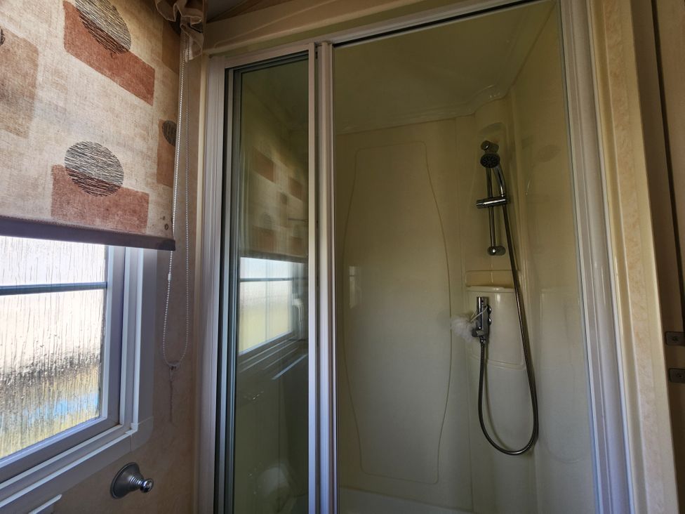 A shower with glass door and window at Whitley bay parkdean resorts - 52 Beechfield