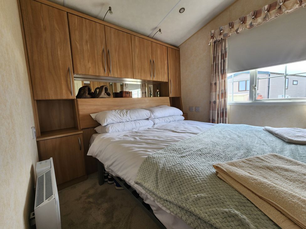 A bedroom with a bed and wardrobe at Whitley bay parkdean resorts - 52 Beechfield, Whitley Bay