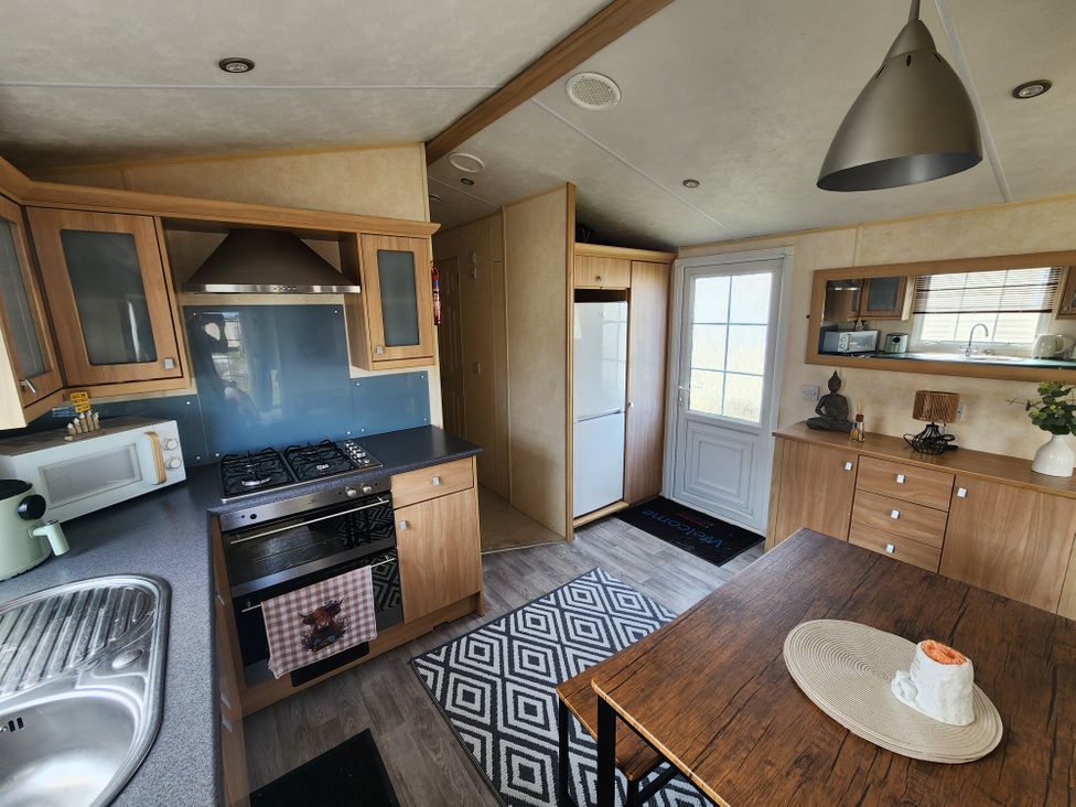 A kitchen with a dining table and appliances at Whitley bay parkdean resorts - 52 Beechfield, Whitley Bay