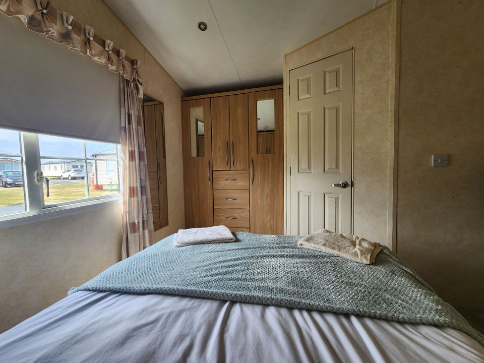 A bedroom with a bed and wardrobe at Whitley bay parkdean resorts - 52 Beechfield in Whitley Bay