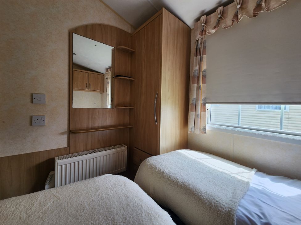 A bedroom with twin beds and a wardrobe at Whitley bay parkdean resorts - 52 Beechfield, Whitley Bay