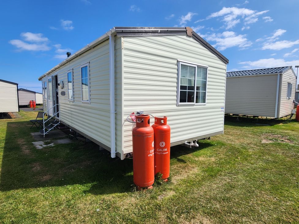 A caravan with gas cylinders outside at Whitley bay parkdean resorts - 52 Beechfield Whitley Bay