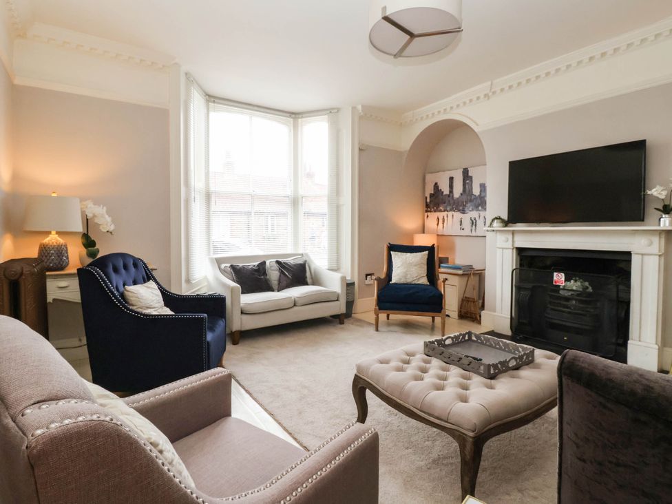 A living room with a sofa and a television at Cadogan House in Easingwold