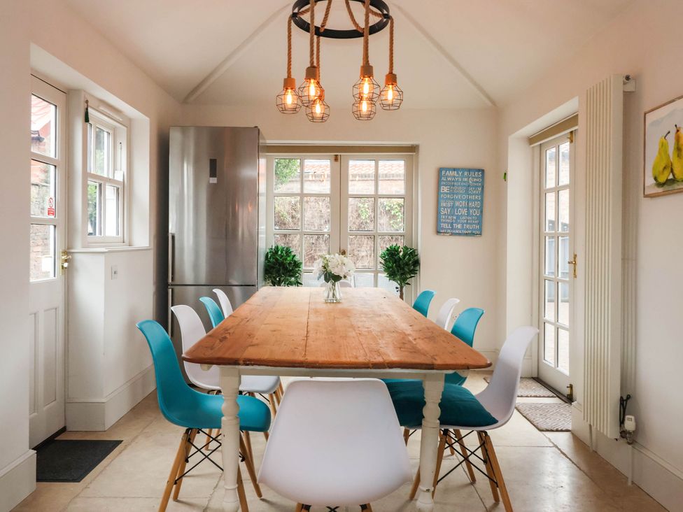 A dining room with a wooden table and chairs at Cadogan House Easingwold