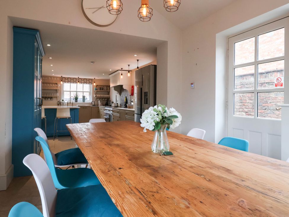 A dining room with a wooden table and chairs at Cadogan House in Easingwold