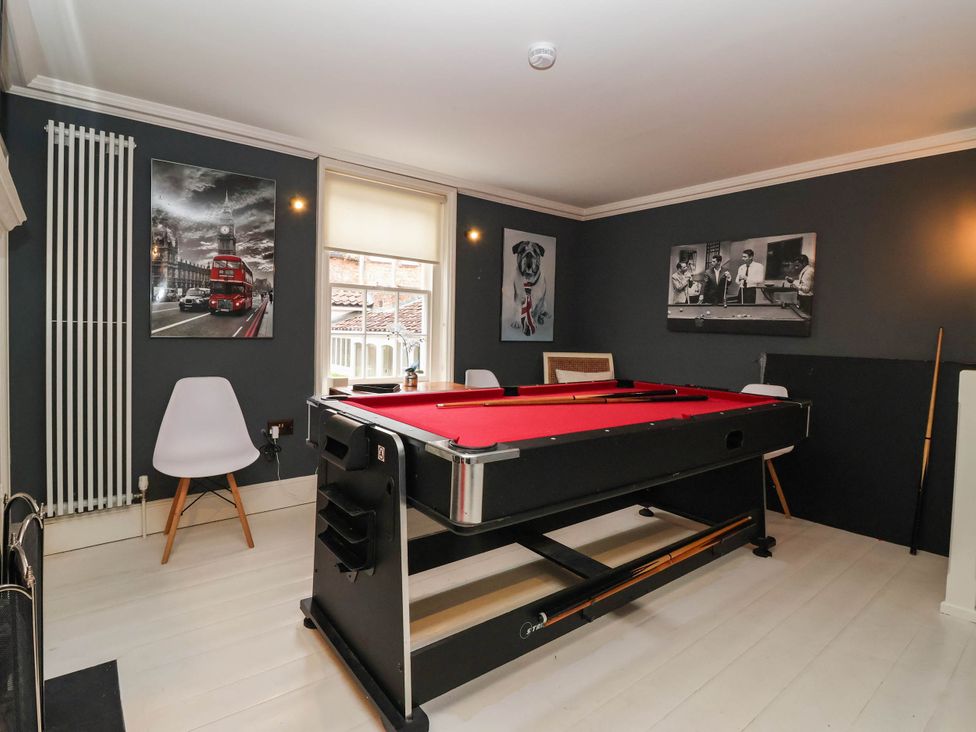 A game room with a pool table and chairs at Cadogan House in Easingwold
