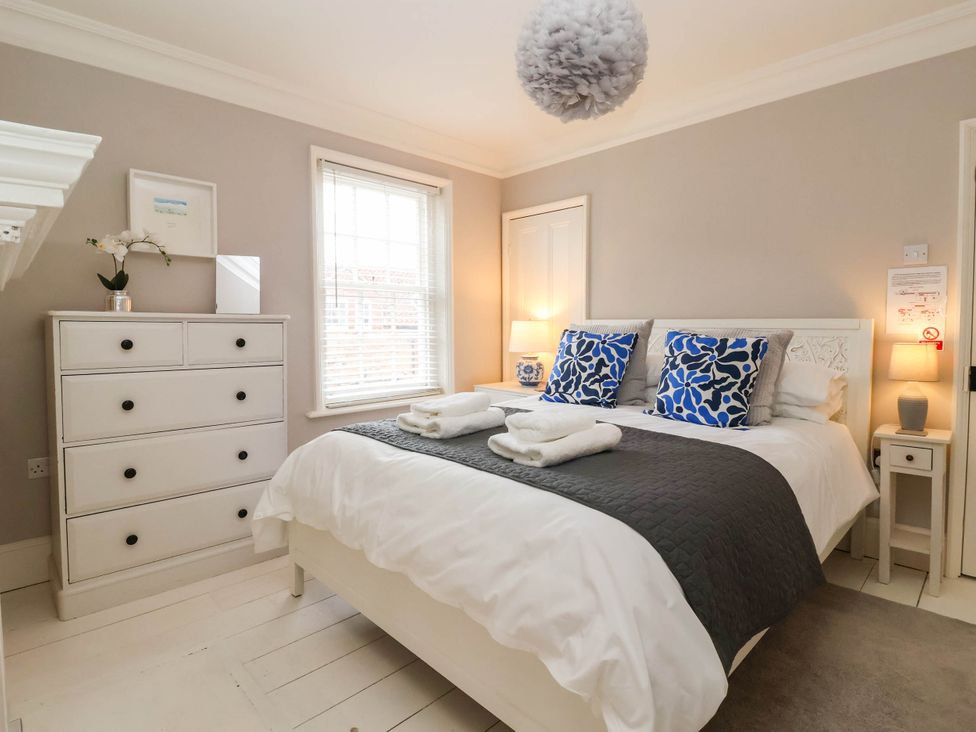 A bedroom with a bed and dresser at Cadogan House in Easingwold