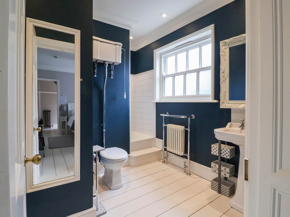 A bathroom with a toilet, sink, and shower stall at Cadogan House Easingwold
