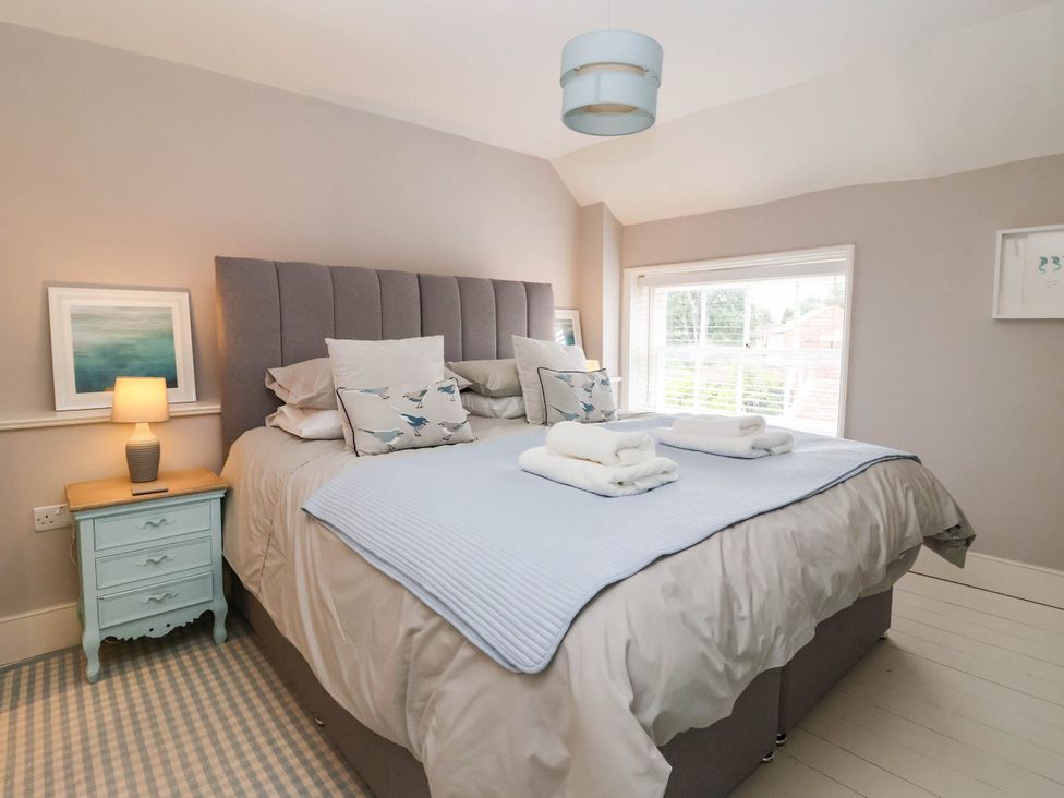A bedroom with a bed and bedside lamp at Cadogan House Easingwold