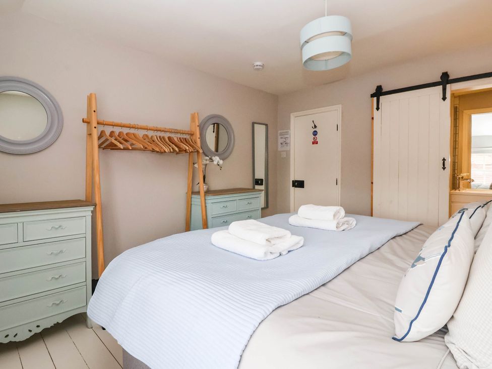 A bedroom with a bed and wardrobe at Cadogan House in Easingwold