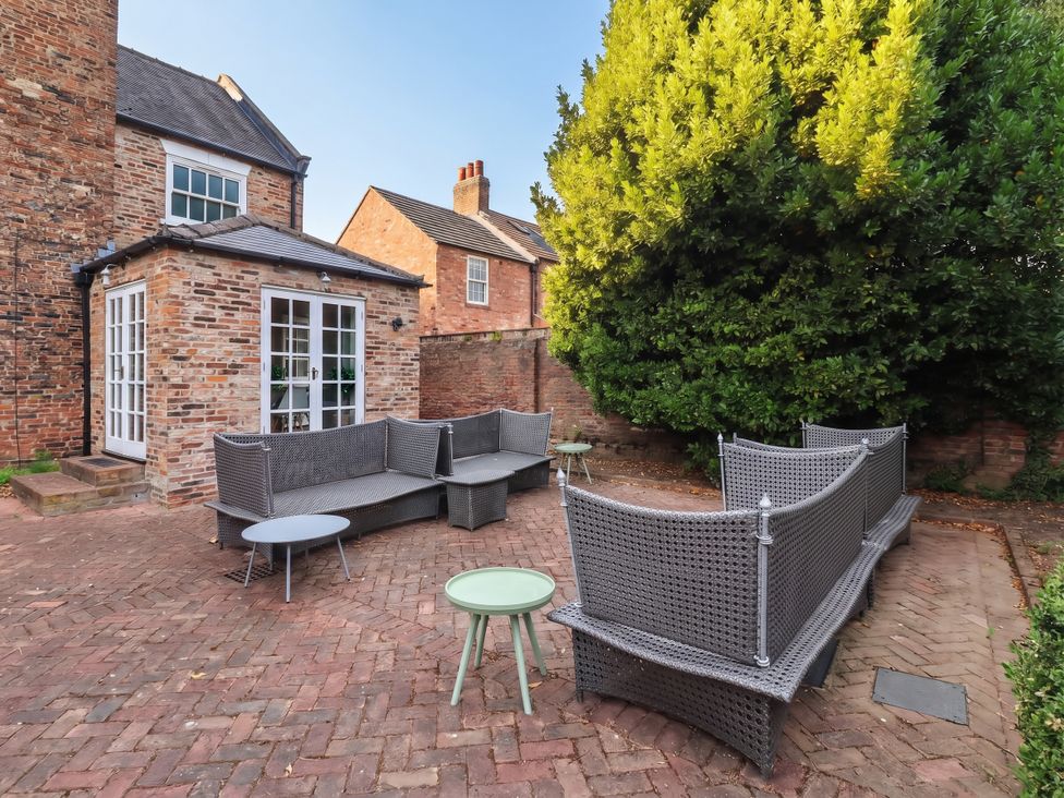 A garden with a sofa and table at Cadogan House Easingwold