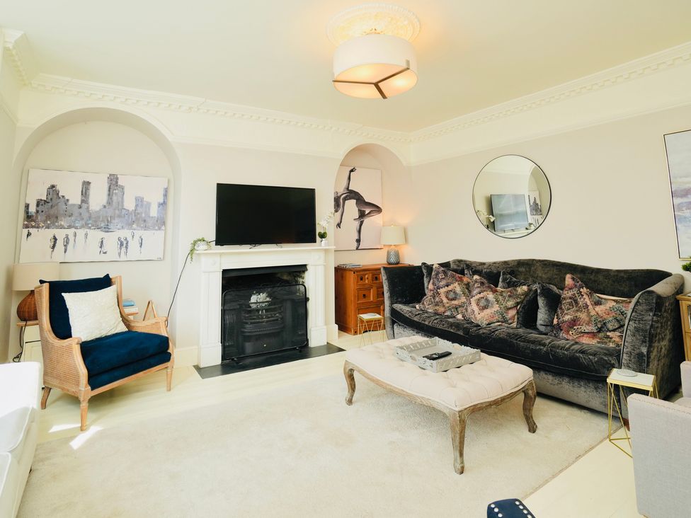 A living room with a sofa and television at Cadogan House Easingwold
