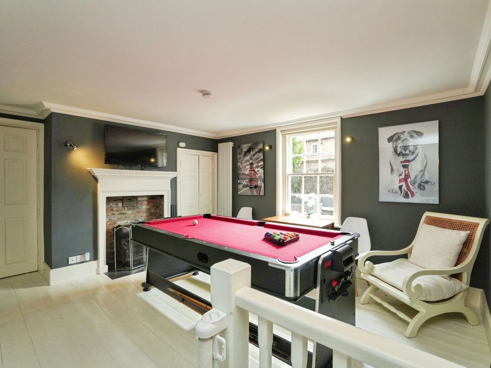 A recreation room with a pool table and television at Cadogan House in Easingwold