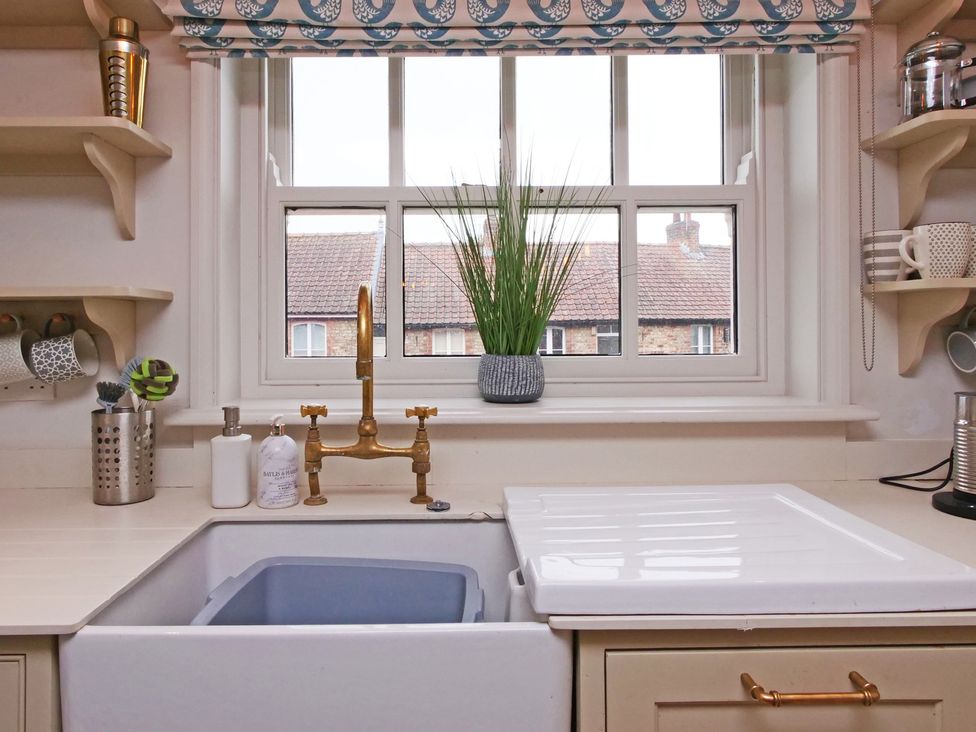 A kitchen with a sink and window at Cadogan House Easingwold