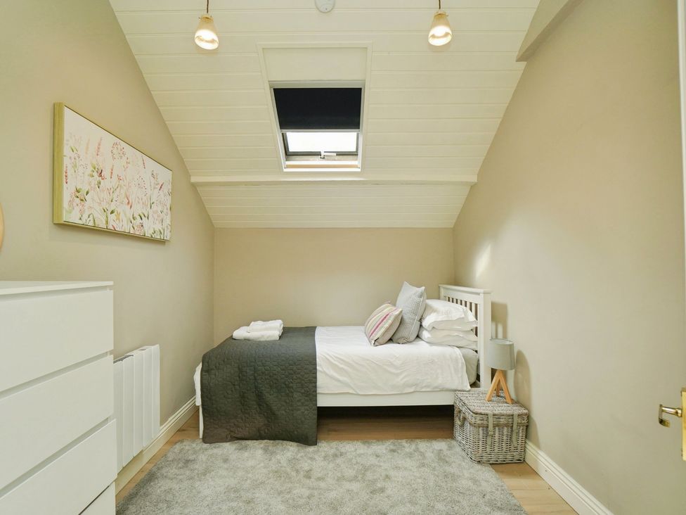 A bedroom with a bed and dresser at Cadogan House in Easingwold