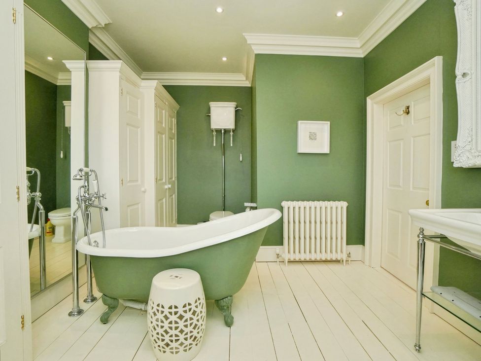 A bathroom with a bathtub and sink at Cadogan House Easingwold