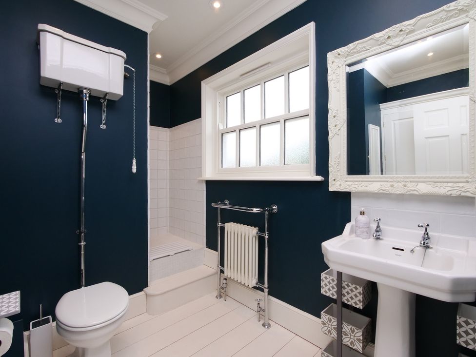 A bathroom with a toilet, sink, and shower at Cadogan House Easingwold