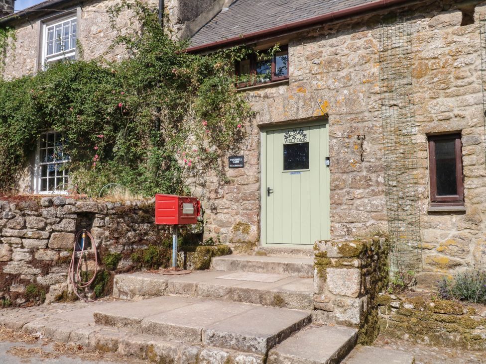 An outdoor area with a door and mailbox at Dashel Cottage at Dockwell Farm near Widecombe-In-The-Moor