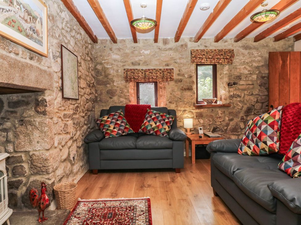 A living room with sofas and a coffee table at Dashel Cottage at Dockwell Farm near Widecombe-In-The-Moor