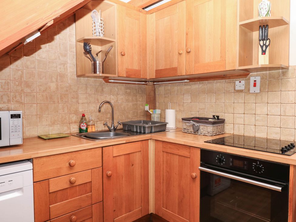 A kitchen with a sink and appliances at Dashel Cottage at Dockwell Farm near Widecombe-In-The-Moor