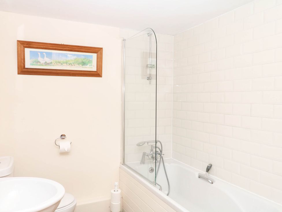 A bathroom with a bathtub and a toilet at Dashel Cottage at Dockwell Farm near Widecombe-In-The-Moor