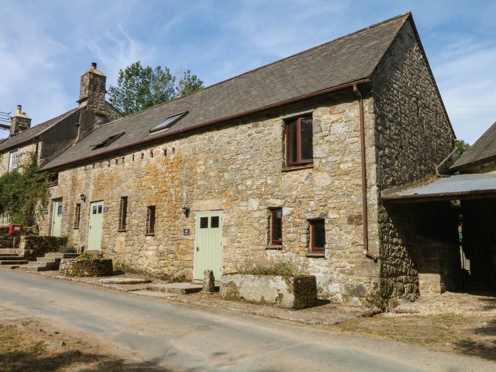 A stone house with green doors near Widecombe-In-The-Moor